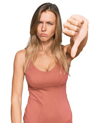 Wall Mural - Beautiful caucasian woman wearing casual clothes looking unhappy and angry showing rejection and negative with thumbs down gesture. bad expression.