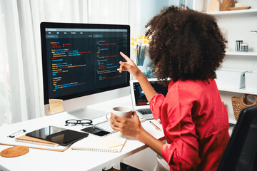 Young working African woman creating coding website developer, thinking data information designer at home office, focusing on laptop Concept of analytical data center in java project job. Tastemaker.