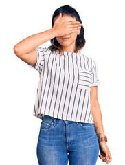 Poster - Young woman wearing casual clothes covering eyes with hand, looking serious and sad. sightless, hiding and rejection concept