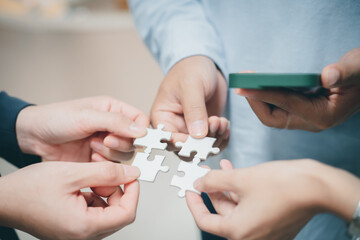 Wall Mural - business strategy ideas Business team planning a strategic meeting Assembling jigsaw pieces, using jigsaw puzzles, showing solutions for business people, teamwork.	