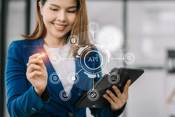 Modern technology and networking concept, woman using tablet with virtual screen API icon Software development tool. API Application Programming Interface.