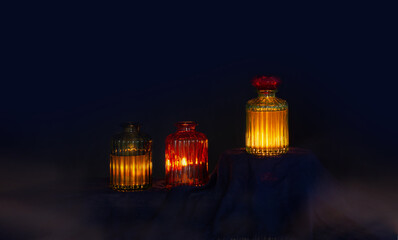 Wall Mural - magic glowing  potions in glass bottles on dark background