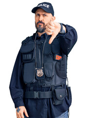 Sticker - Young handsome man wearing police uniform looking unhappy and angry showing rejection and negative with thumbs down gesture. bad expression.