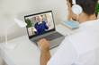© Studio Romantic - Acquiring new skills. Man in headphones watches video recording of business training or online webinar on laptop. Close-up of laptop on screen of which friendly senior businessman talks about business
