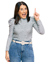 Poster - Middle age brunette woman wearing casual clothes pointing finger up with successful idea. exited and happy. number one.