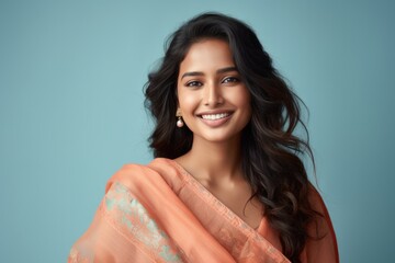 Wall Mural - Portrait of a smiling young Indian female wearing traditional dress