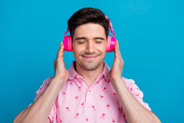 Canvas Print - Photo of peaceful satisfied person closed eyes arms touch headphones listen new playlist isolated on blue color background