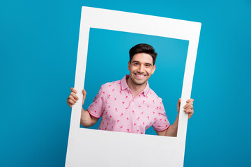 Canvas Print - Portrait of nice cheerful young man hands hold paper album set card isolated on blue color background