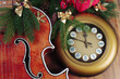 Vintage clock, guitar, fir branches and Christmas decorations.