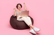 Full size photo of ecstatic overjoyed girl dressed stylish blouse sit on pouf with laptop win betting isolated on pink color background