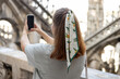 Beautiful 30s woman taking selfie on Roof of Milan Cathedral Duomo di Milano, Italy. Traveling Europe in summer. Attractive female is exploring city. Top tourist attraction