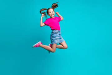 Sticker - Full size photo of optimistic positive girl dressed pink t-shirt flying clenching fists having fun isolated on turquoise color background