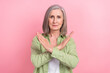 Photo of sad upset senior lady wear stylish green clothes two hands crossed stop ageism bullying isolated on pink color background