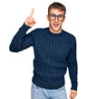 © Krakenimages.com - Young blond man wearing casual clothes and glasses pointing finger up with successful idea. exited and happy. number one.