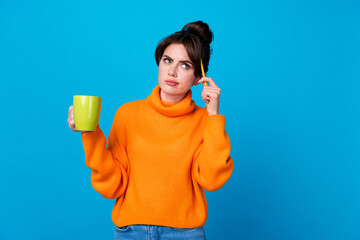 Sticker - Photo of suspicious unsure lady wear knitted pullover drinking coffee thinking pen head looking empty space isolated blue color background