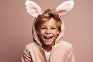 Wall Mural - Cheerful child in a funny suit with bunny ears, laughing boy in an Easter suit looking at camera