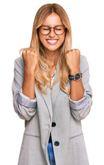 Sticker - Beautiful blonde young woman wearing business clothes excited for success with arms raised and eyes closed celebrating victory smiling. winner concept.