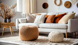 Fototapeta  - Knitted pouf near white fabric sofa with blanket and terra cotta pillows