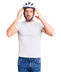 Poster - Young handsome man wearing bike helmet with hand on head for pain in head because stress. suffering migraine.