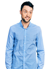 Poster - Hispanic man with beard wearing casual business shirt smiling looking to the side and staring away thinking.