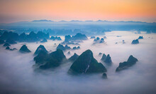 Aerial View Of Guilin Mountain Landscape At Sunrise With Low Clouds Over The Valley And Fog, Guangxi, China.