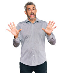 Poster - Middle age grey-haired man wearing casual clothes afraid and terrified with fear expression stop gesture with hands, shouting in shock. panic concept.