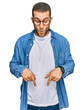 © Krakenimages.com - Young caucasian man wearing casual clothes pointing down with fingers showing advertisement, surprised face and open mouth