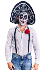 Poster - Man wearing day of the dead costume over background in shock face, looking skeptical and sarcastic, surprised with open mouth