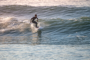 Wall Mural - Young surfer enjoying waves