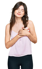 Sticker - Young beautiful caucasian girl wearing casual clothes smiling with hands on chest with closed eyes and grateful gesture on face. health concept.