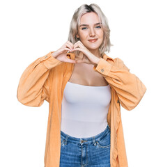 Canvas Print - Young blonde girl wearing casual clothes smiling in love showing heart symbol and shape with hands. romantic concept.