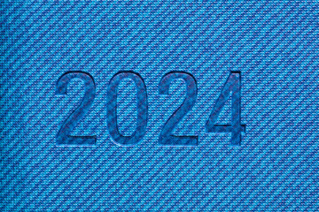 2024 inscription embossed on blue ribbed background