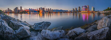 Panoramic view of Vancouver skyline with modern buildings along the False Creek at sunset, British Columbia, Canada.