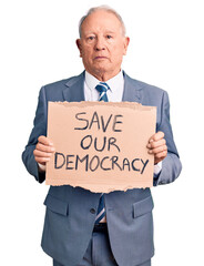 Sticker - Senior handsome grey-haired man holding save our democracy cardboard banner thinking attitude and sober expression looking self confident