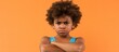 © The 2R Artificiality - An African American child with curly hair is wearing swimwear while looking skeptical and nervous, with a disapproving expression on their face and crossed arms, giving off a negative vibe.