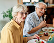 senior mature elderly couple active family lunch food woman meal eating mother dinner father grandfather grandmother home table parent grandparent