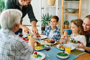 child family lunch food woman meal eating mother dinner man father together happy daughter home tabl