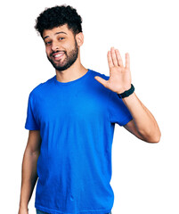 Sticker - Young arab man with beard wearing casual blue t shirt waiving saying hello happy and smiling, friendly welcome gesture