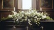 Coffin in the church with white flowers. Funeral ceremony