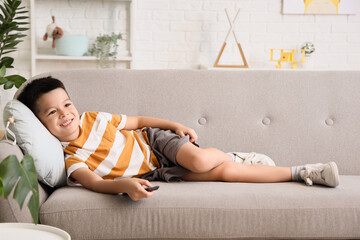 Poster - Little Asian boy watching TV at home