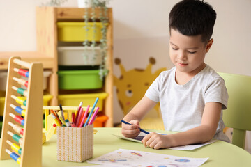 Canvas Print - Little Asian boy drawing at home