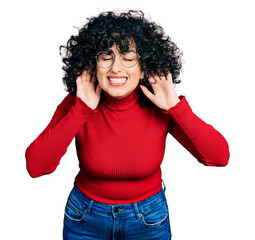 Poster - Young middle east girl wearing casual clothes and glasses trying to hear both hands on ear gesture, curious for gossip. hearing problem, deaf