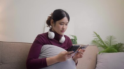 Wall Mural - Young Asian woman is Filling credit card information to make an online payment.