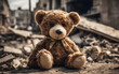  Kids teddy bear toy in a city burned by destruction of an aftermath war conflict