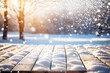 Christmas winter background. White snow on wooden table. Xmas scene on floor board. Cold blue ice. Empty space on desk top. New year sun light sky snowy day. Trees blur in bokeh. Frost on plank deck