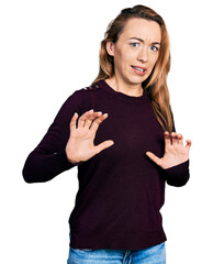 Canvas Print - Young caucasian woman wearing casual clothes disgusted expression, displeased and fearful doing disgust face because aversion reaction. with hands raised