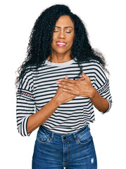 Wall Mural - Middle age african american woman wearing casual clothes smiling with hands on chest with closed eyes and grateful gesture on face. health concept.