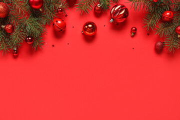 Wall Mural - Red Christmas balls and fir branches on color background