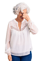 Wall Mural - Senior grey-haired woman wearing casual clothes tired rubbing nose and eyes feeling fatigue and headache. stress and frustration concept.