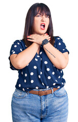 Canvas Print - Young plus size woman wearing casual clothes shouting suffocate because painful strangle. health problem. asphyxiate and suicide concept.